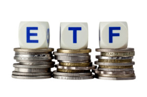 Stacks of coins with the letters ETF isolated on white background